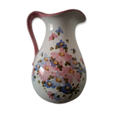Old ceramic pitcher with floral decoration.