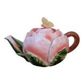 Ceramic teapot in the shape of a rose with a butterfly and raised petals.