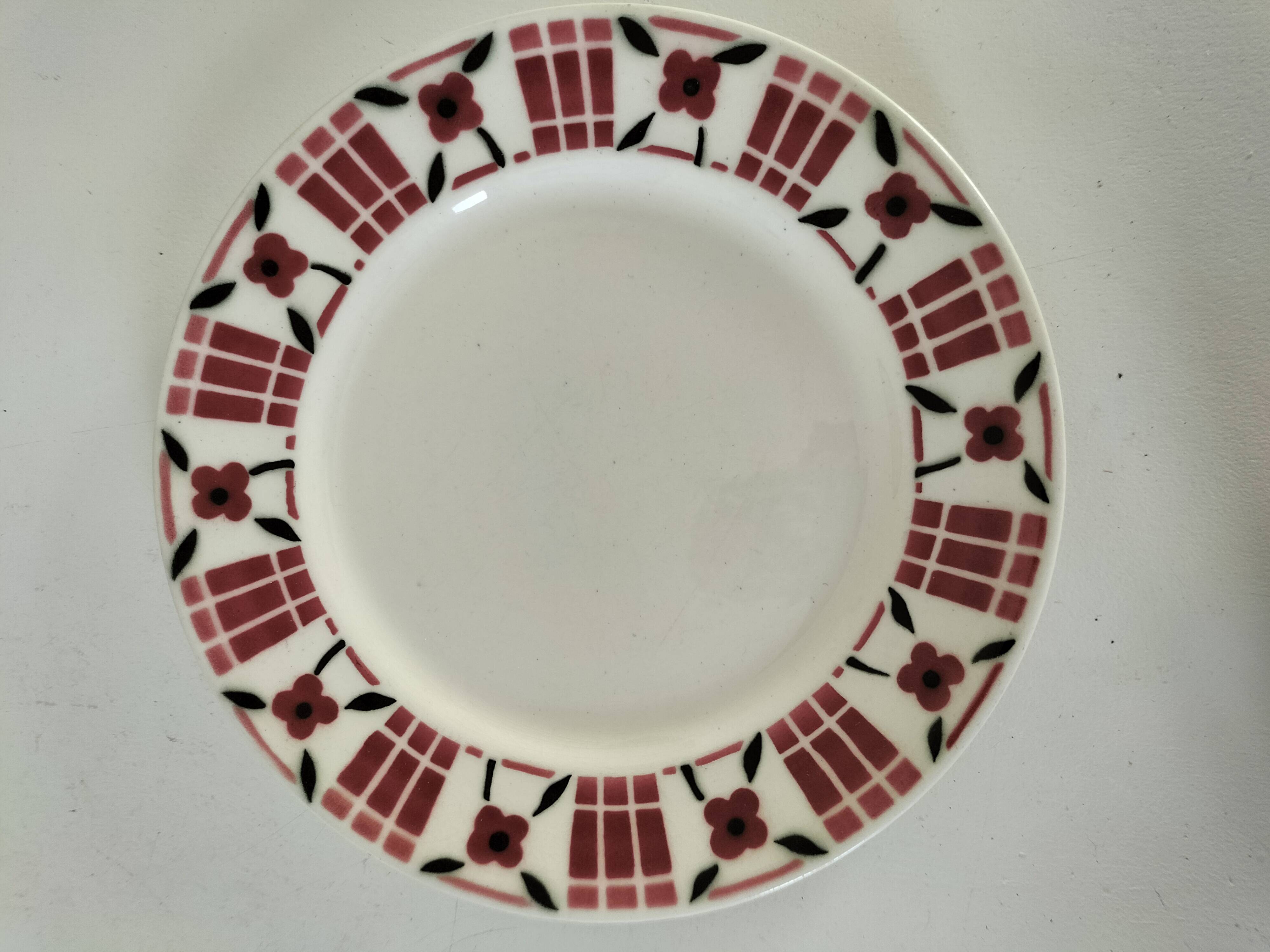 Set of 8 ironstone plates with coordinated designs.