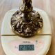 Solid bronze candlesticks decorated with putti, acanthus leaves and lion heads