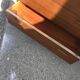 Mid-century teak chest of drawers in brown with four drawers, brass handles, 1960s.