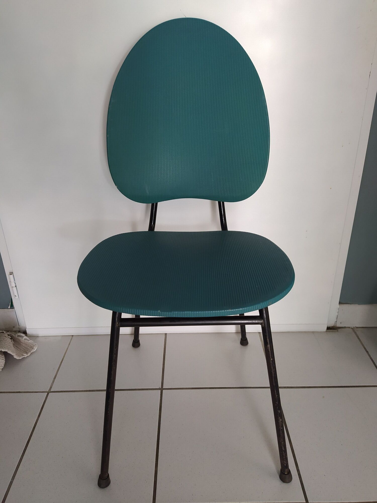 Vintage chair in turquoise green vinyl with black metal legs
