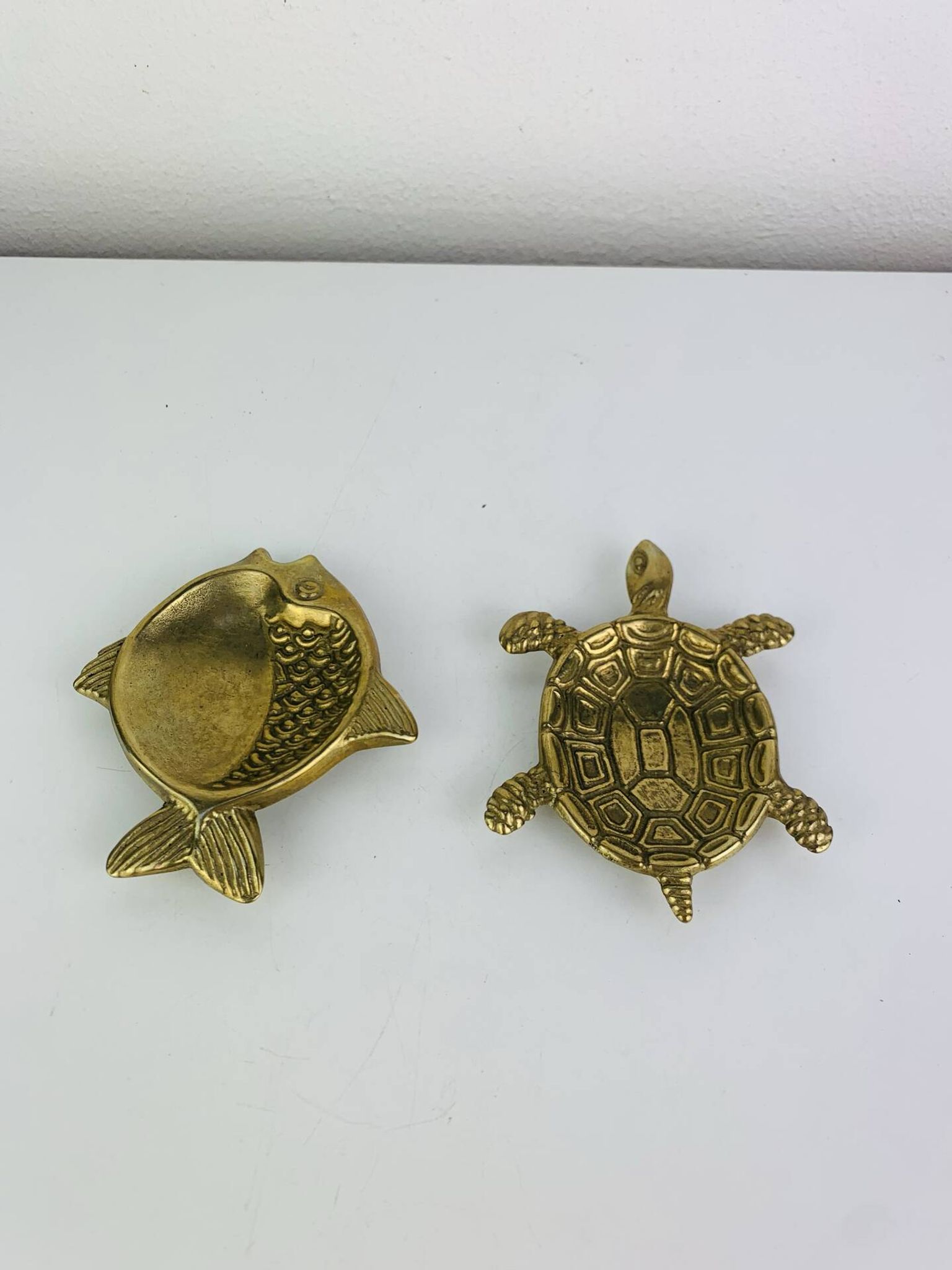Pair of animal trinket trays in brass, fish and turtle.