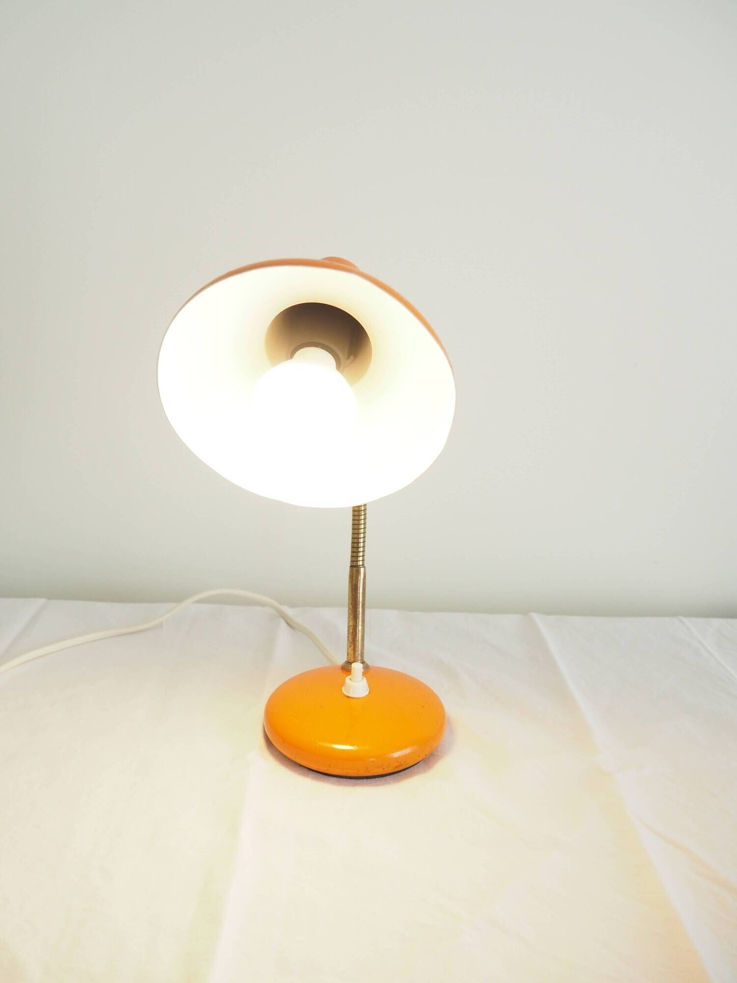 Orange colored metal desk lamp from the 1960s-1970s