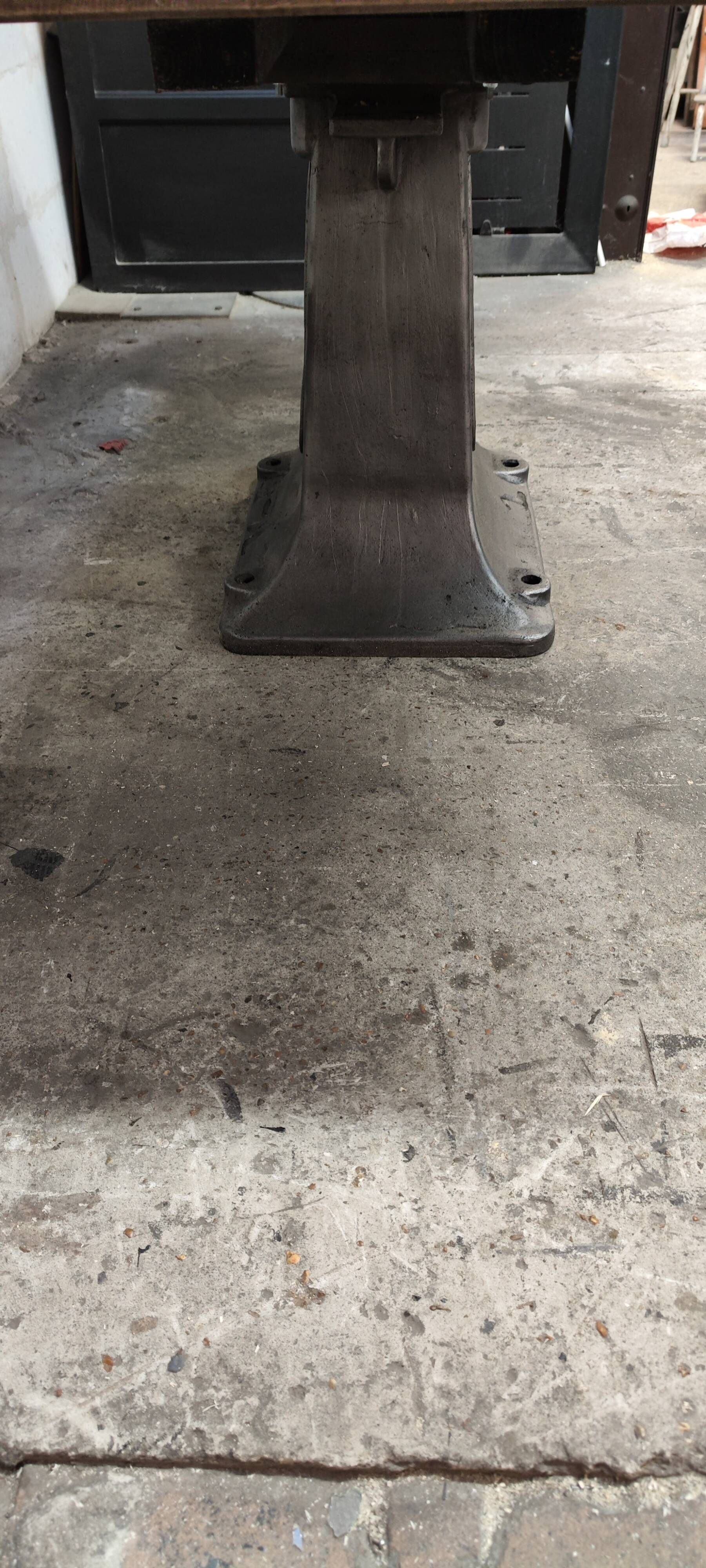 Industrial table with oak top and cast iron central leg