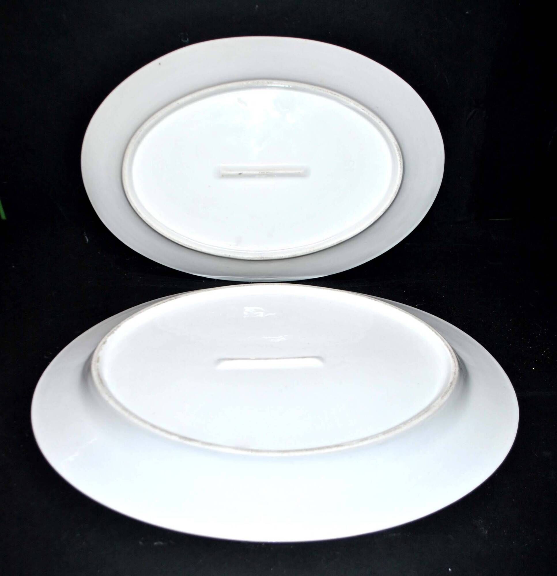 Limoges set of 2 old oval porcelain dishes with green and gold edging