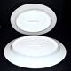 Limoges set of 2 old oval porcelain dishes with green and gold edging