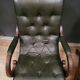 Pair of English Chesterfield armchairs in leather and solid wood