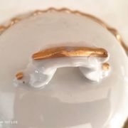 White porcelain sugar bowl decoration in relief and green and gold frieze
