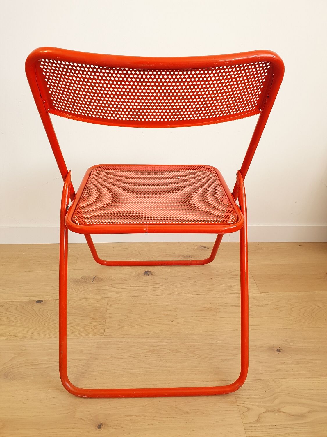 Perforated metal folding chair