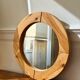 Round mirror in raw wood