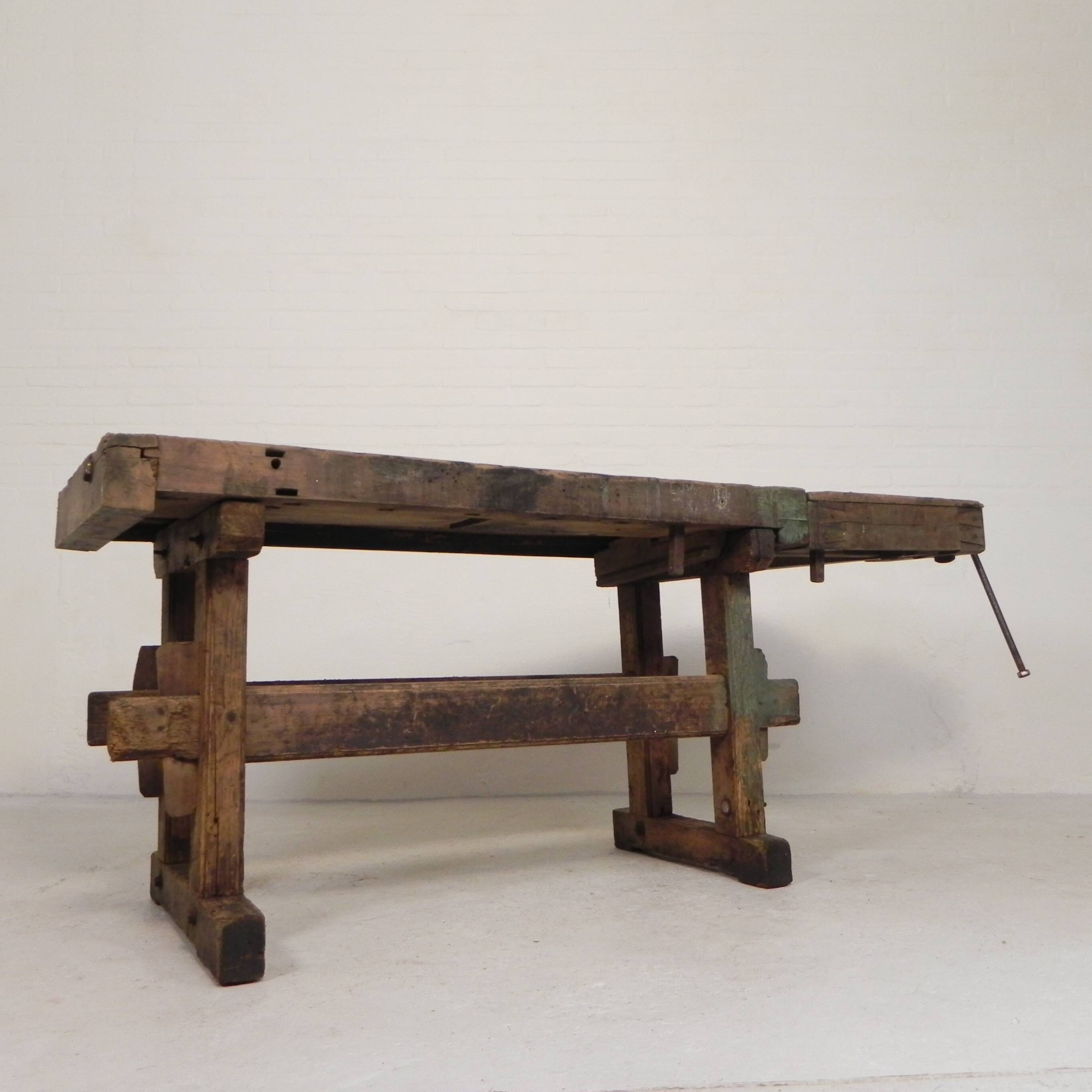 Wooden industrial workbench with vice, 194 cm long, 1930s.