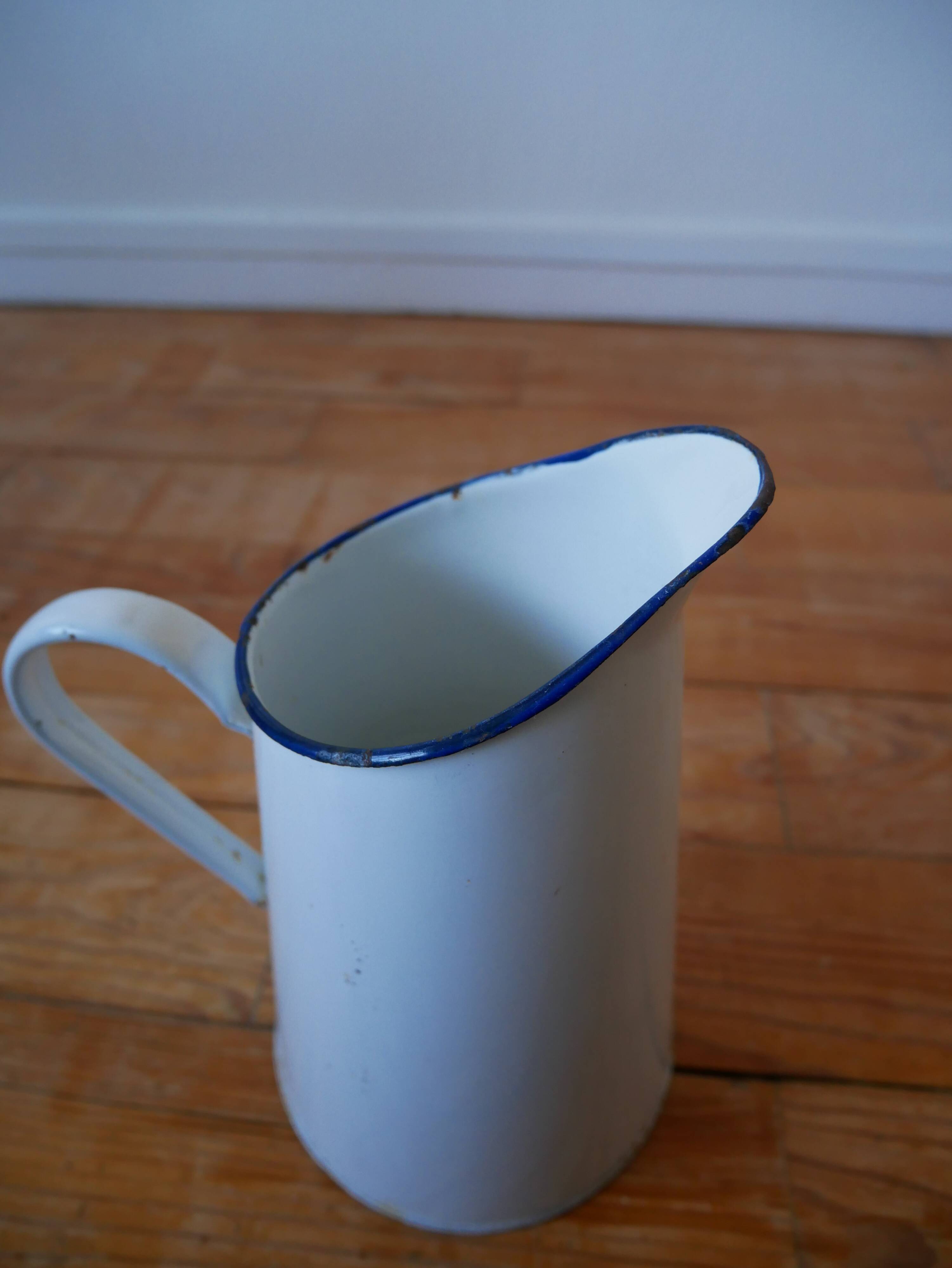 White enamelled metal broc