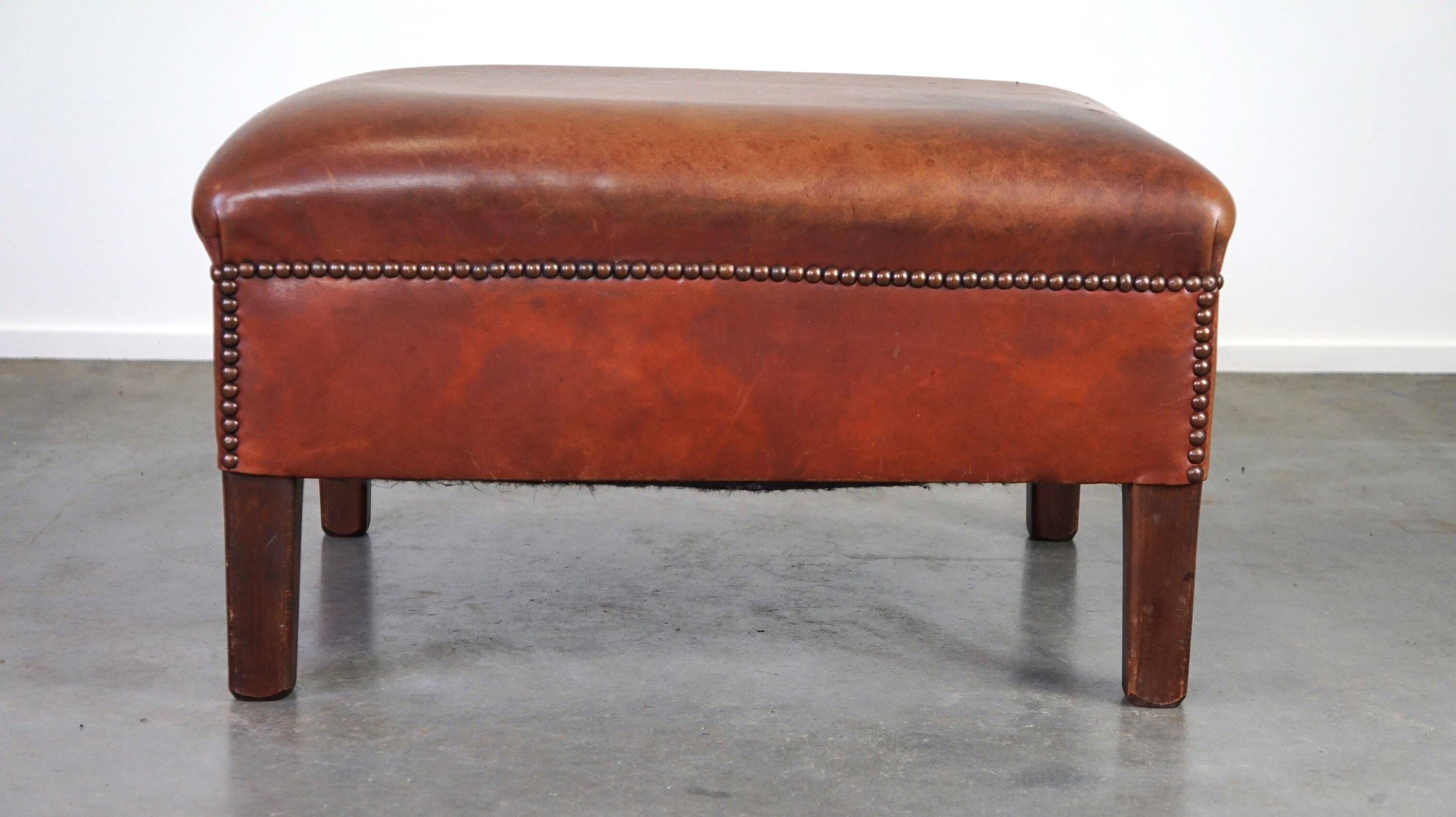 Leather ottoman in classic English style finished with decorative nails