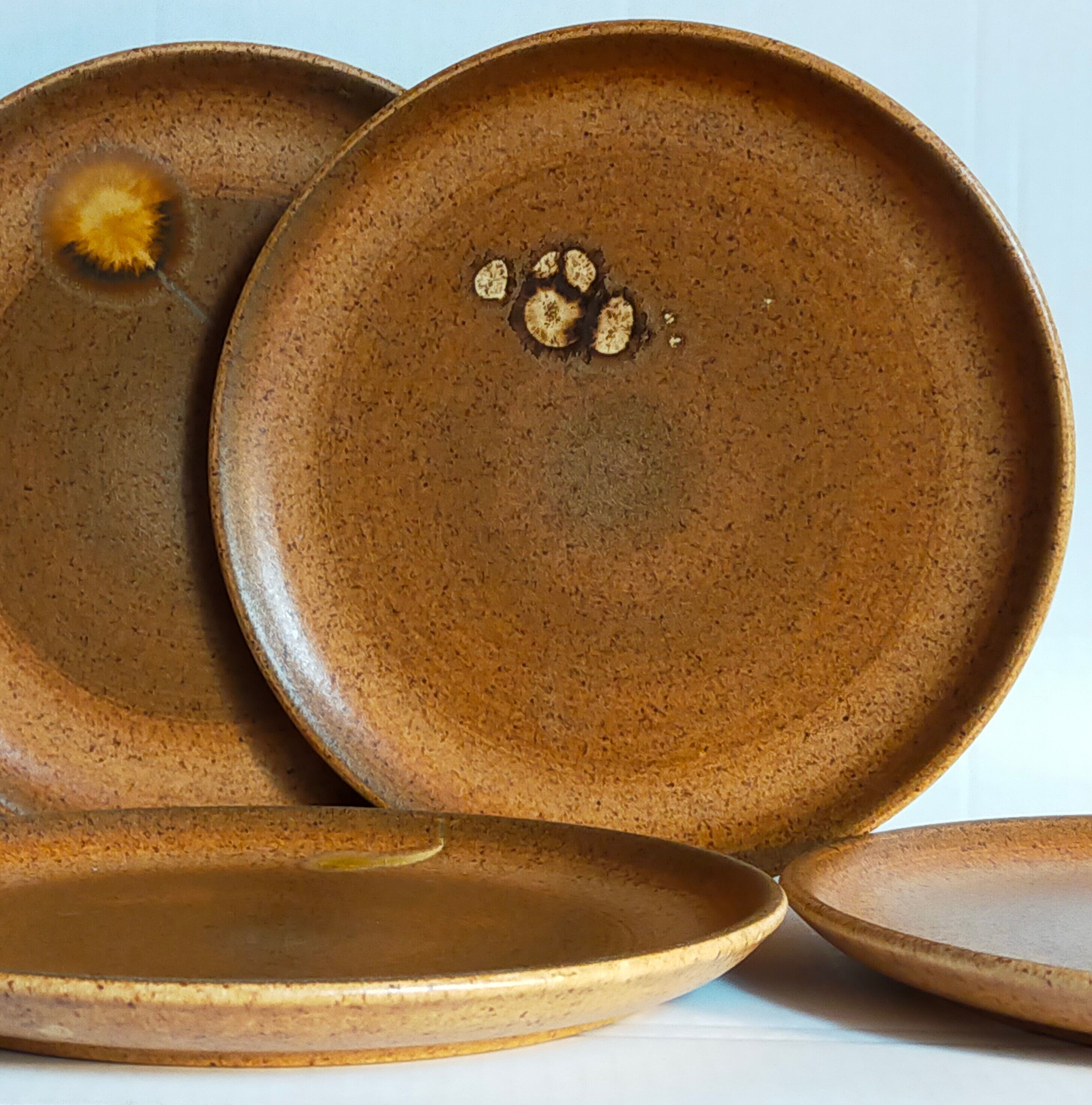 Four vintage glazed stoneware potter's plates