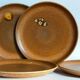 Four vintage glazed stoneware potter's plates