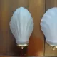 Pair of Art Deco shell wall sconces in frosted glass and brass.