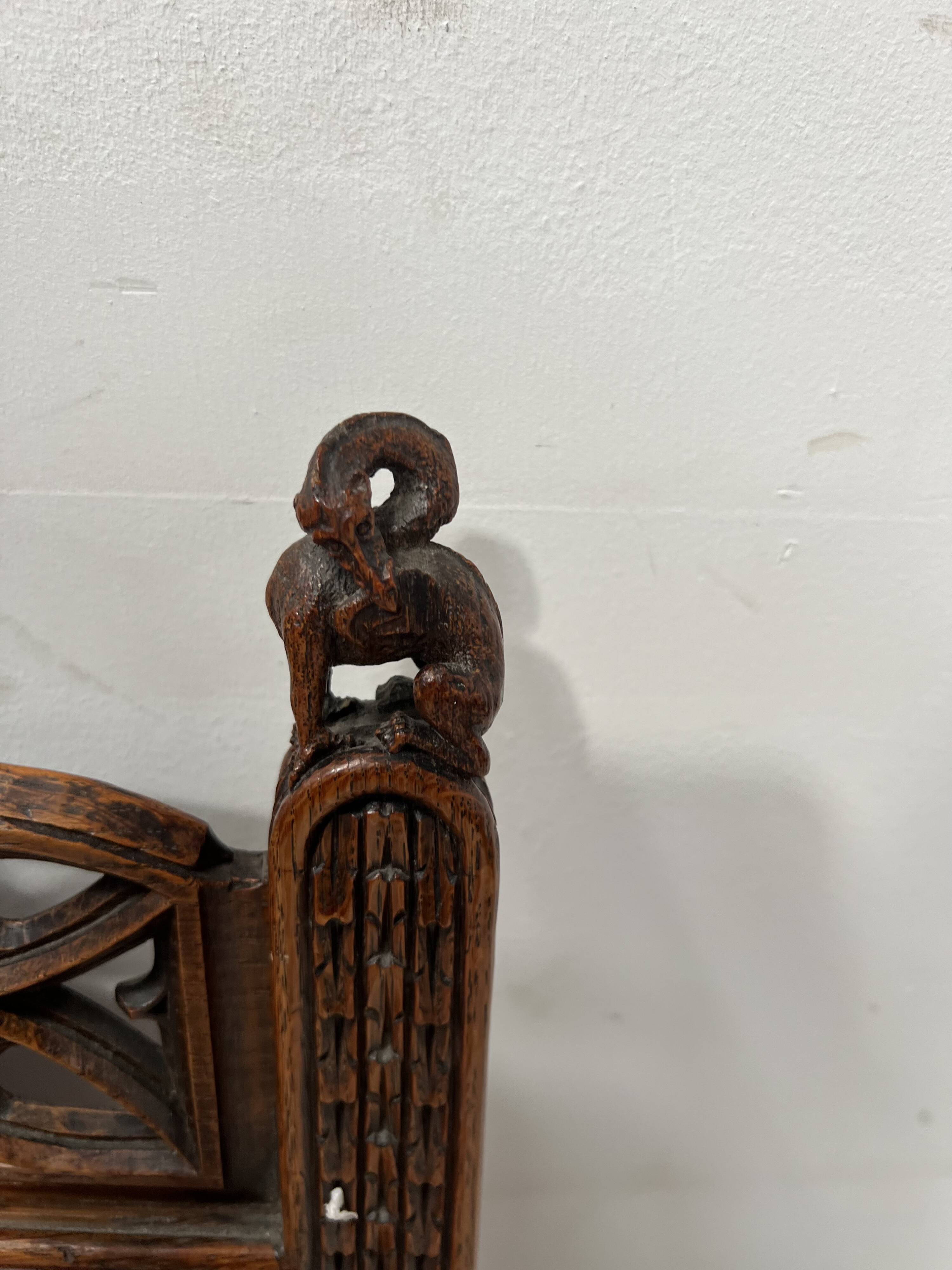 Pair of Gothic-style walnut lounge chairs, 19th century