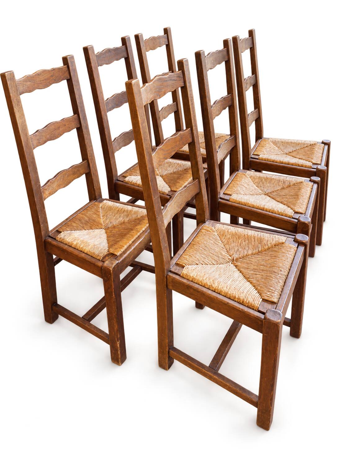 Set of 6 wooden chairs with straw seats and high backs.