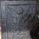 huge old fireplace plate has decoration of angels, crown and fleurs-de-lis
