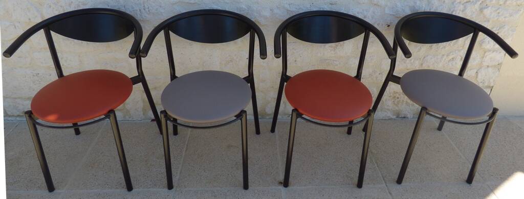 4 gondola-style chairs with a sturdy metal frame and faux leather.