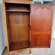 Louis XV rustic bonnetière in solid cherry wood, late 19th to early 20th century.