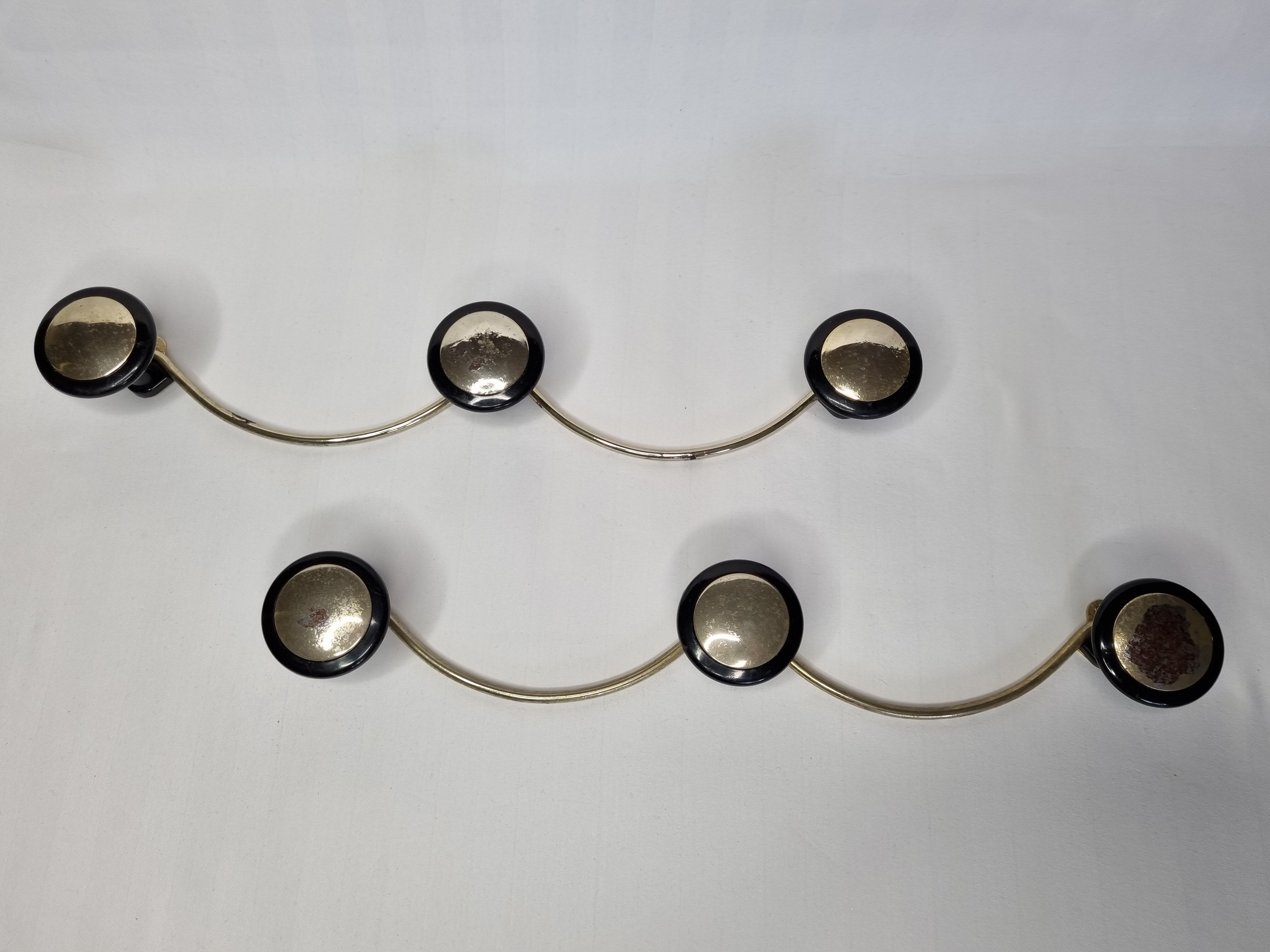 Pair of vintage wall coat racks in gold metal