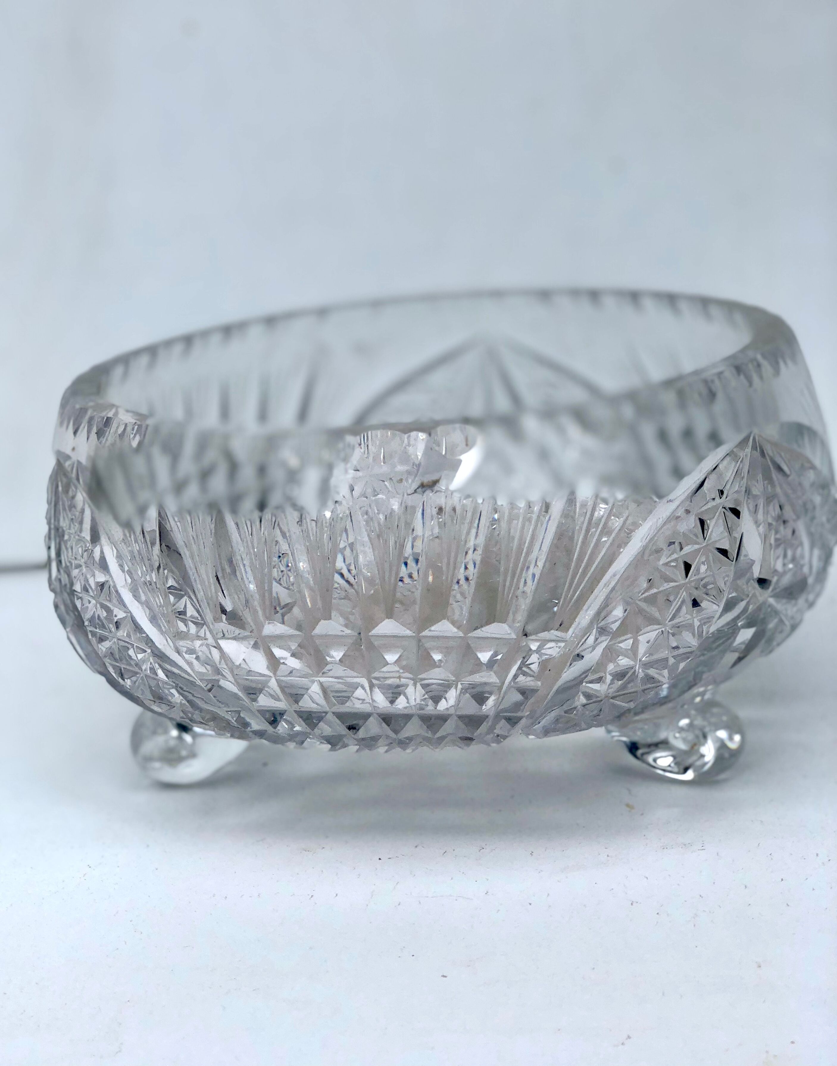 Chiseled glass basket cup on legs