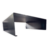 Coffee table with raw metal steel leaf.