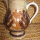 Glazed stoneware jug with hand decoration