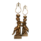 Two carved wooden children, table lamps.