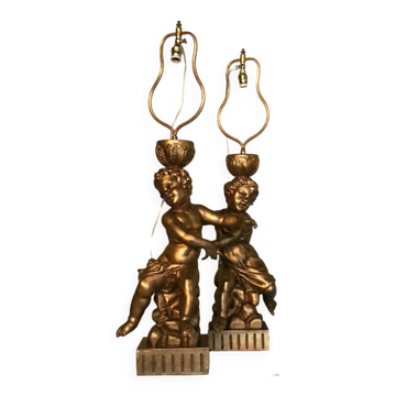 Two carved wooden children, table lamps.