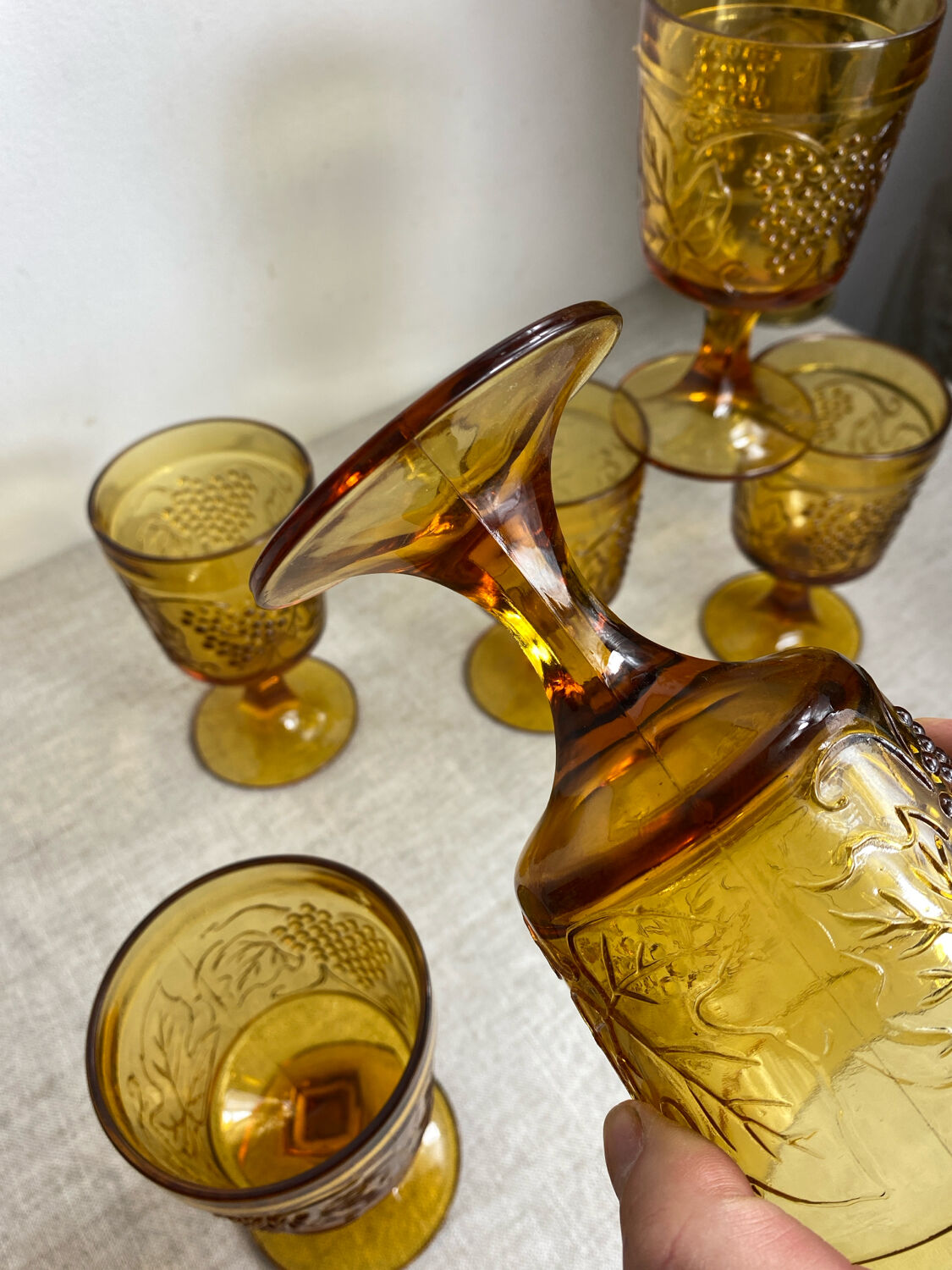 Six stemmed glasses in amber-colored molded glass