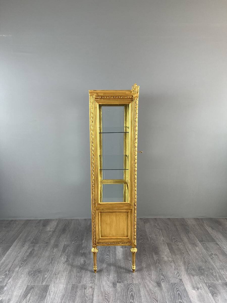 Carved and gilded wooden display cabinet, Louis XVI style, 20th century.