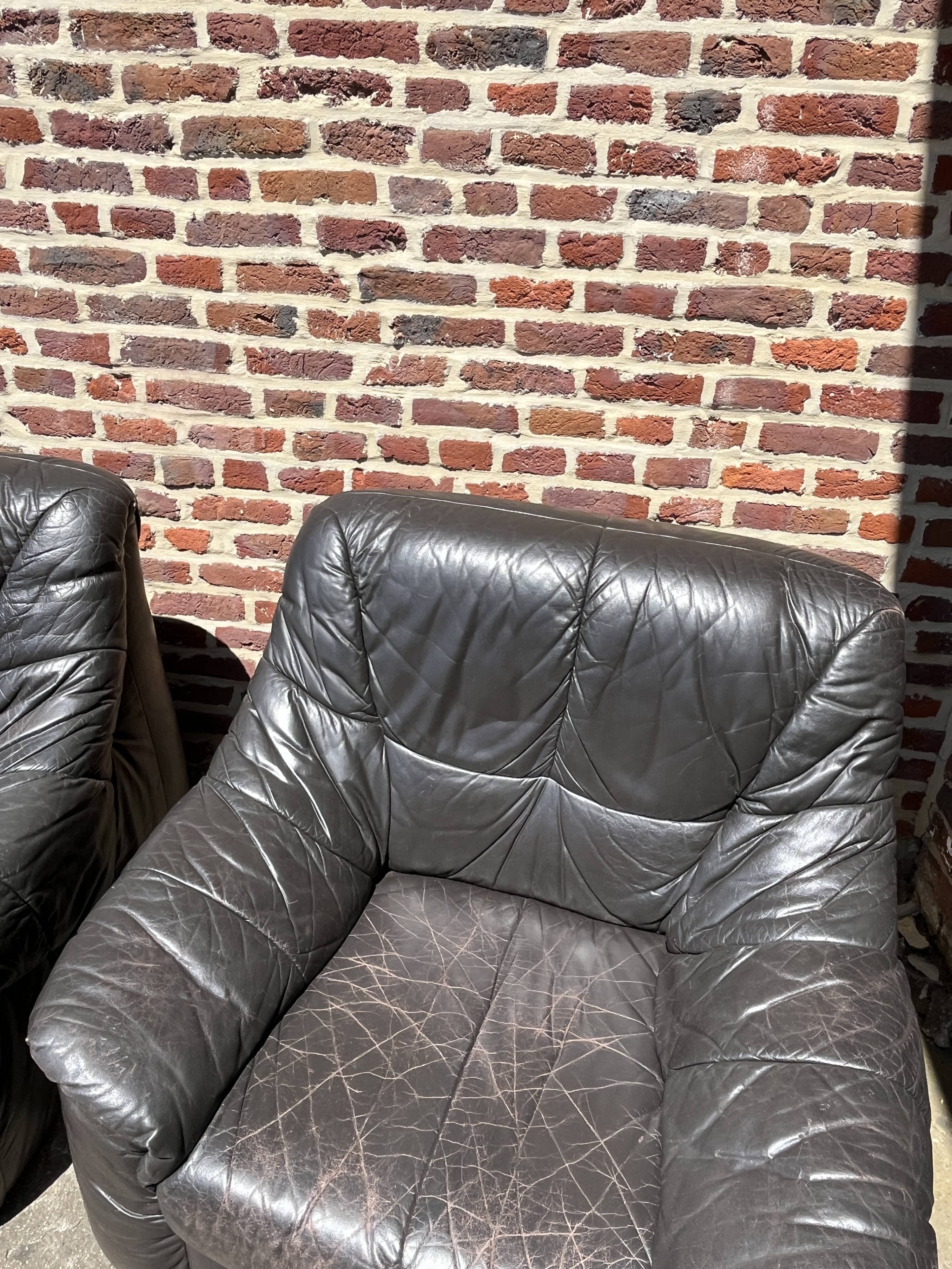 Pair of patinated leather club armchairs