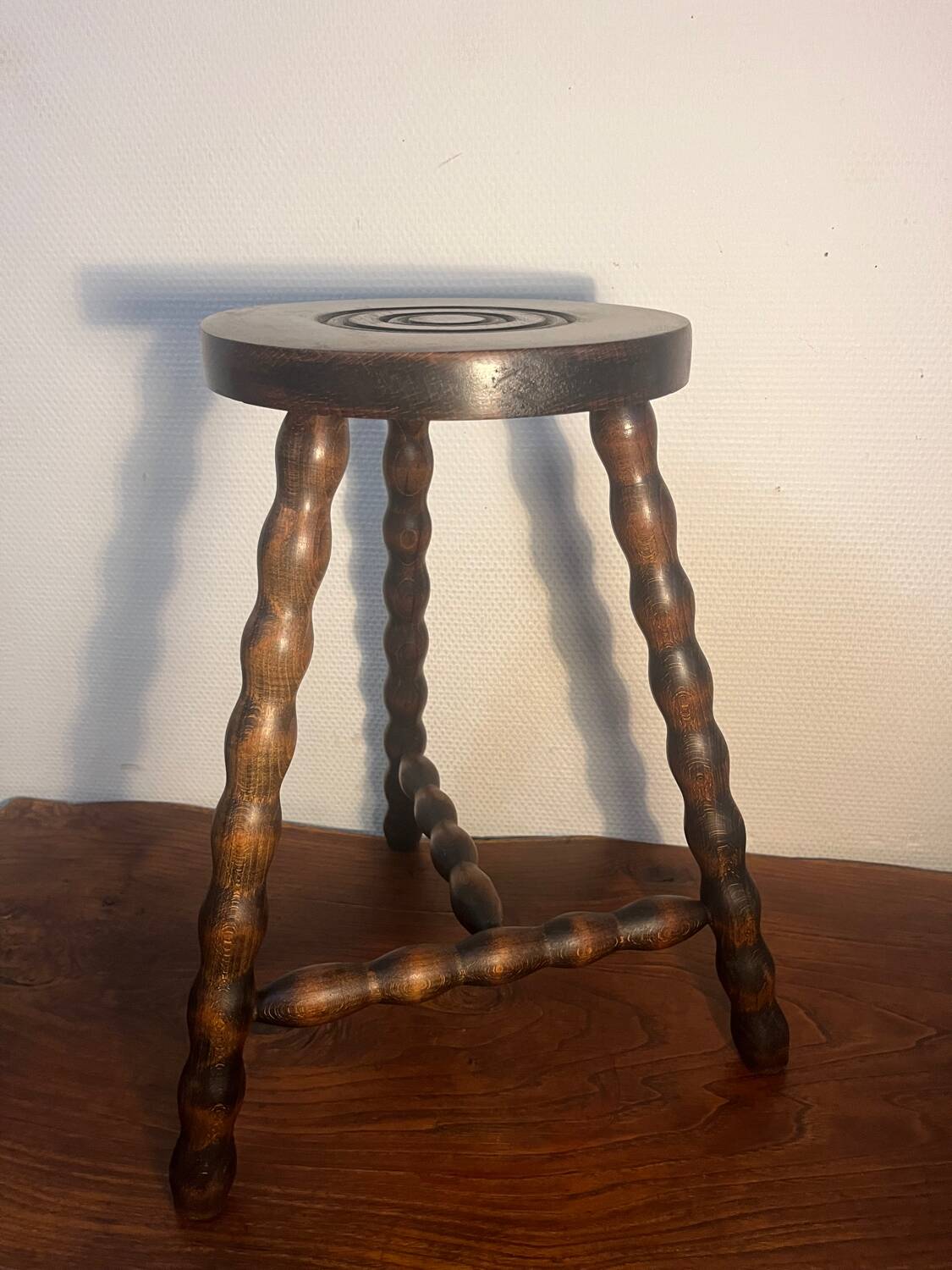 Round tripod stool with turned wooden legs