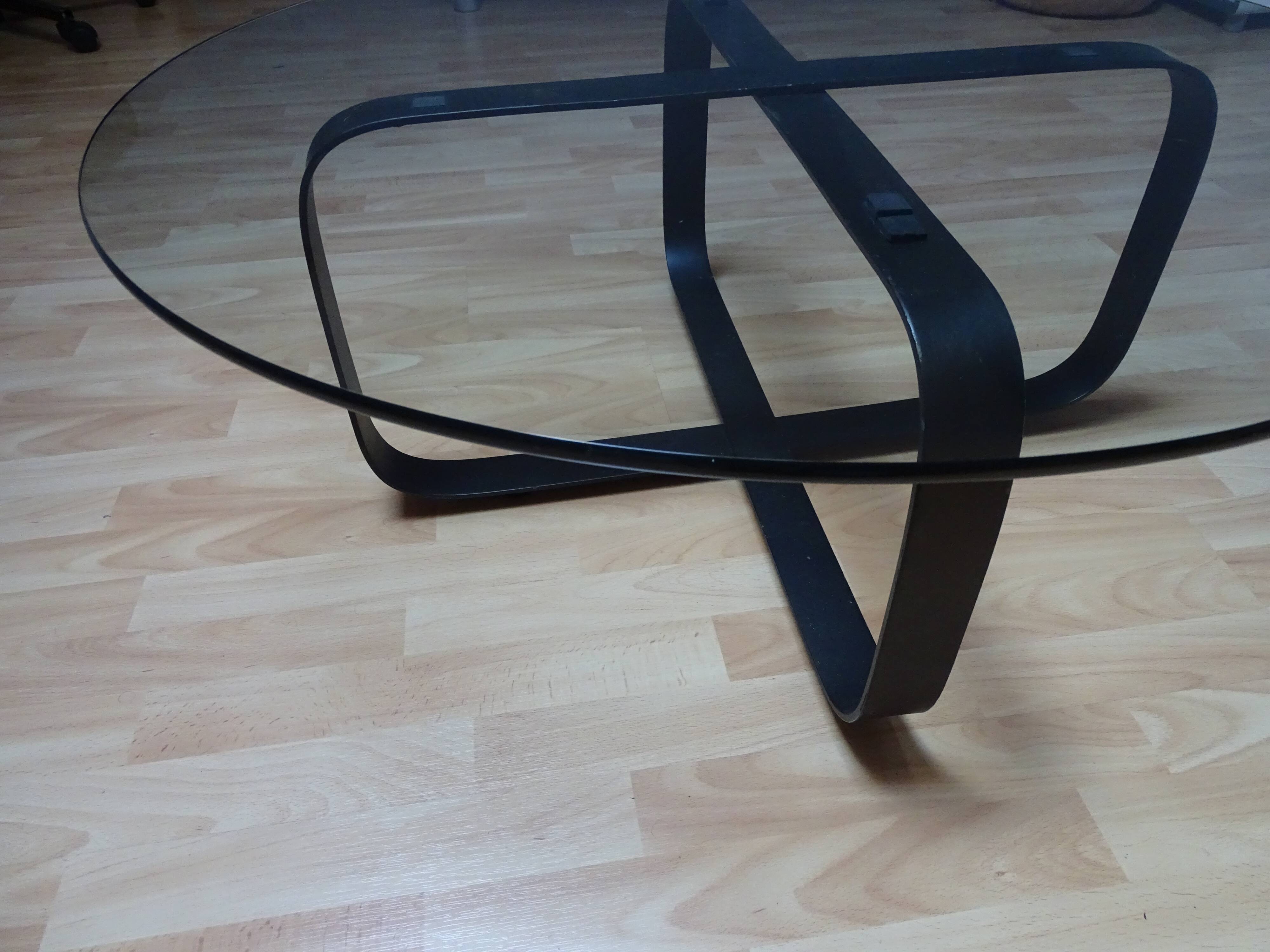 Design round glass coffee table, crossed legs