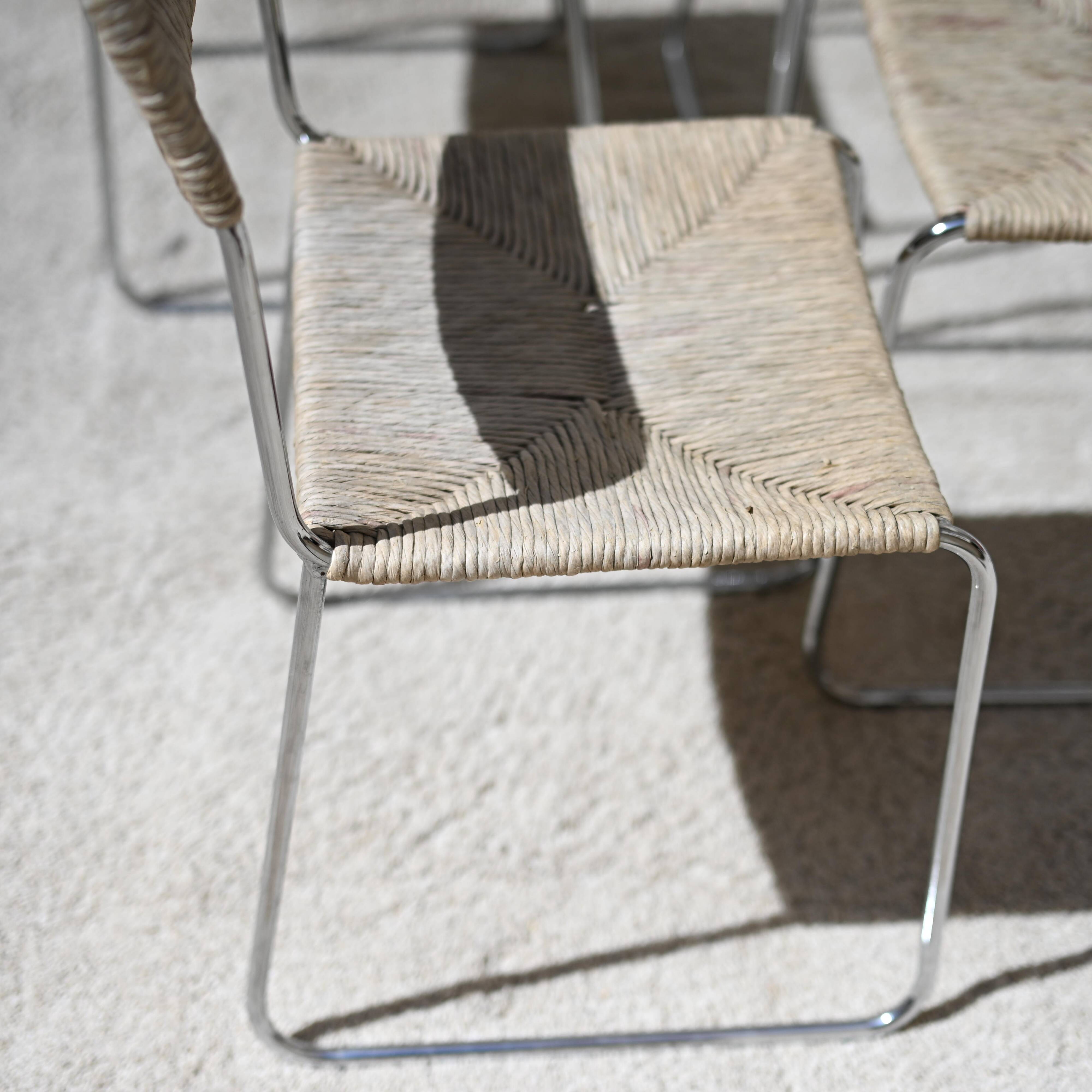 Four straw-seated chairs from 1980.