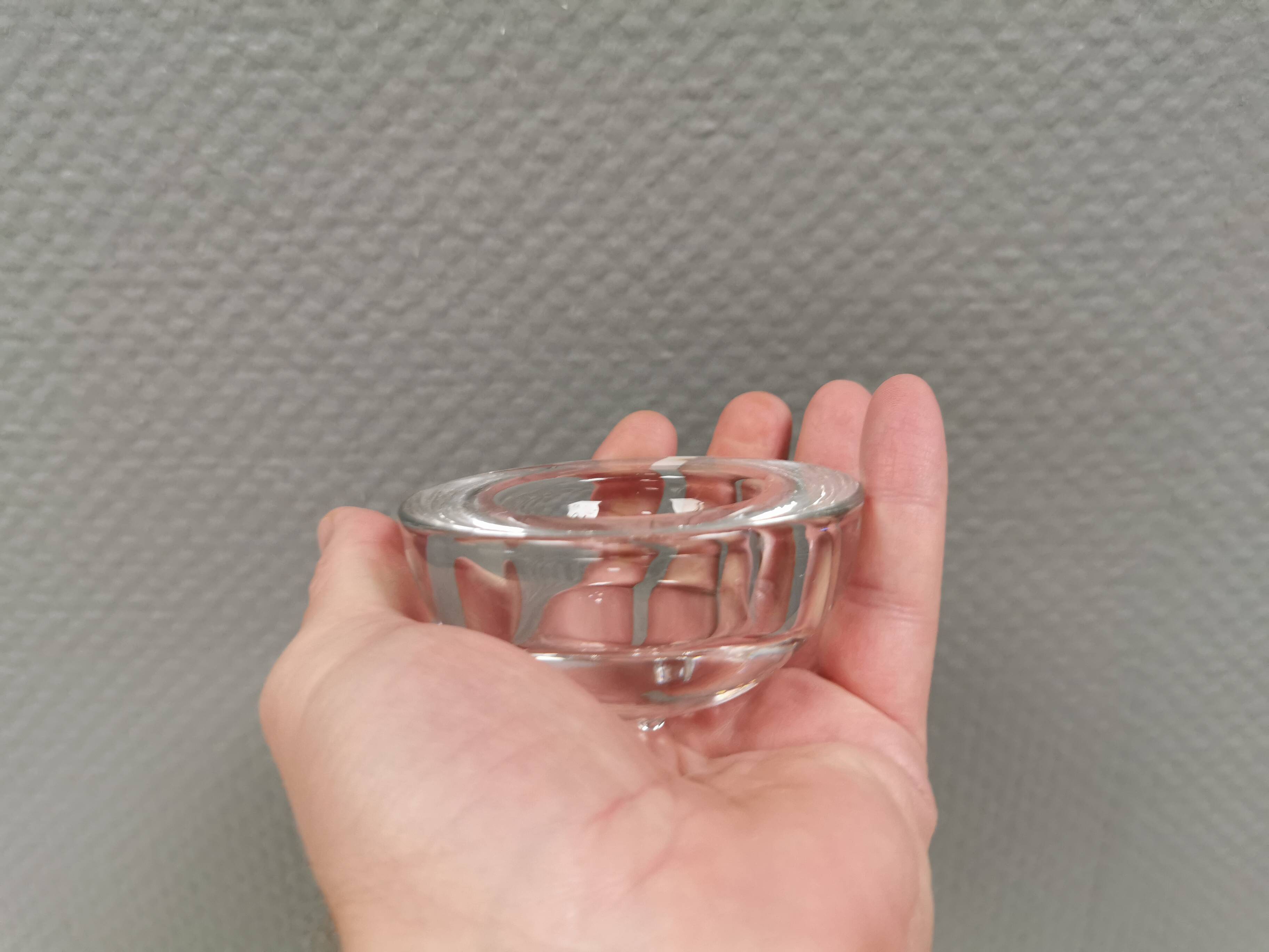 A set of iittala candle holders in clear transparent glass.