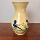 Large vase in glazed pottery decorated with blue birds and flowers.