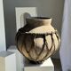 Very large light grey terracotta pot with handles and rattan crossbars.