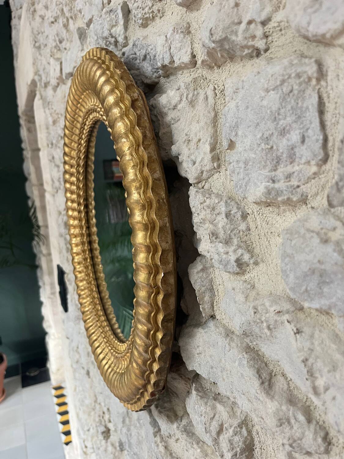 Pair of antique oval mirrors gilded with gold leaf and mercury.
