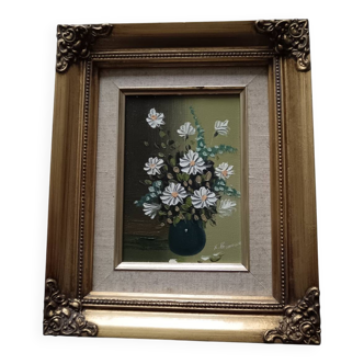 Oil painting of a bouquet of flowers and its beautiful frame.