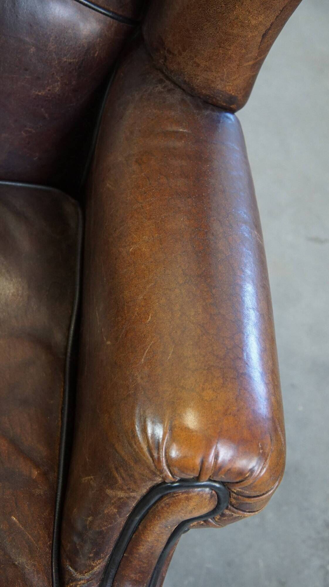 Wing chair made of sheepskin and neatly finished with black piping