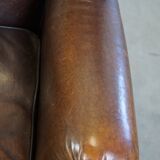 Wing chair made of sheepskin and neatly finished with black piping