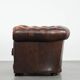 Brown Chesterfield armchair made of cowhide leather in English style