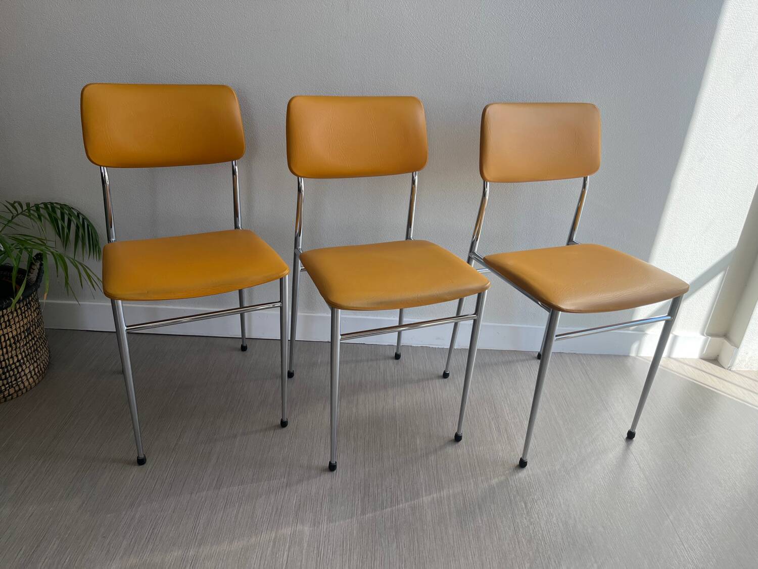 LM vintage chrome and orange/mustard yellow faux leather chairs