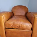 Leather club armchair and its pouf