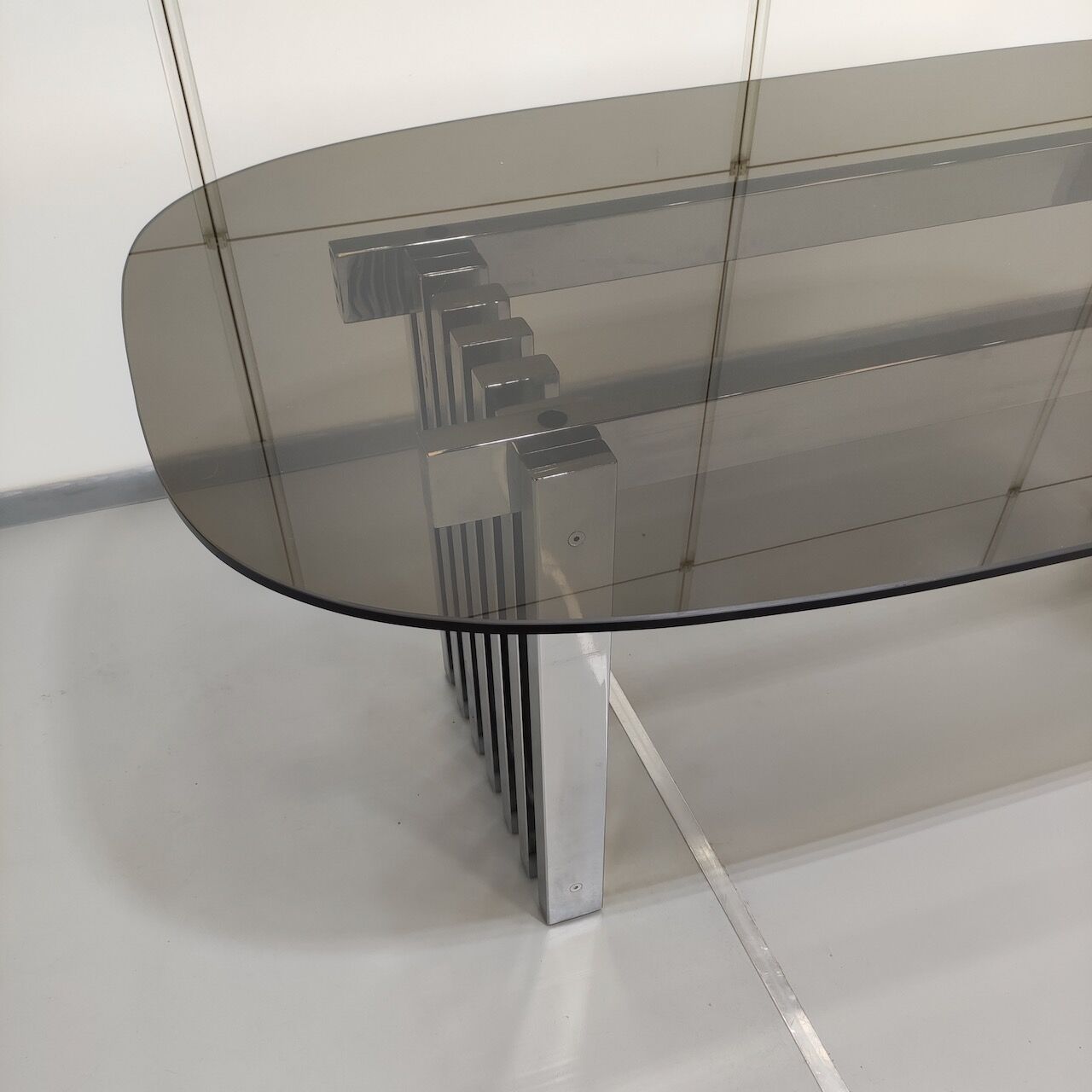 Chrome base diningroom table with smoked glass oval top