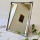 Antique framed mirror, bevelled glass and silver-plated metal frame, 1930-1940.